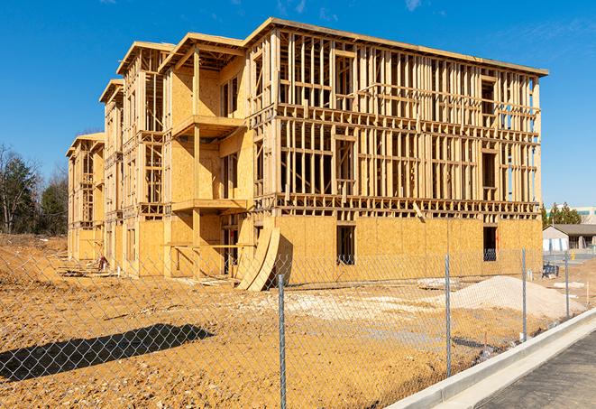 workers protected by temporary barrier fence during building maintenance in Oceanside, CA